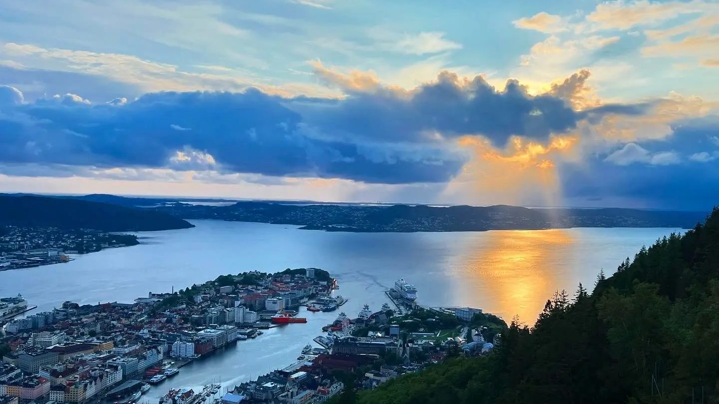 Low summer sun over a Norwegian fjord and city