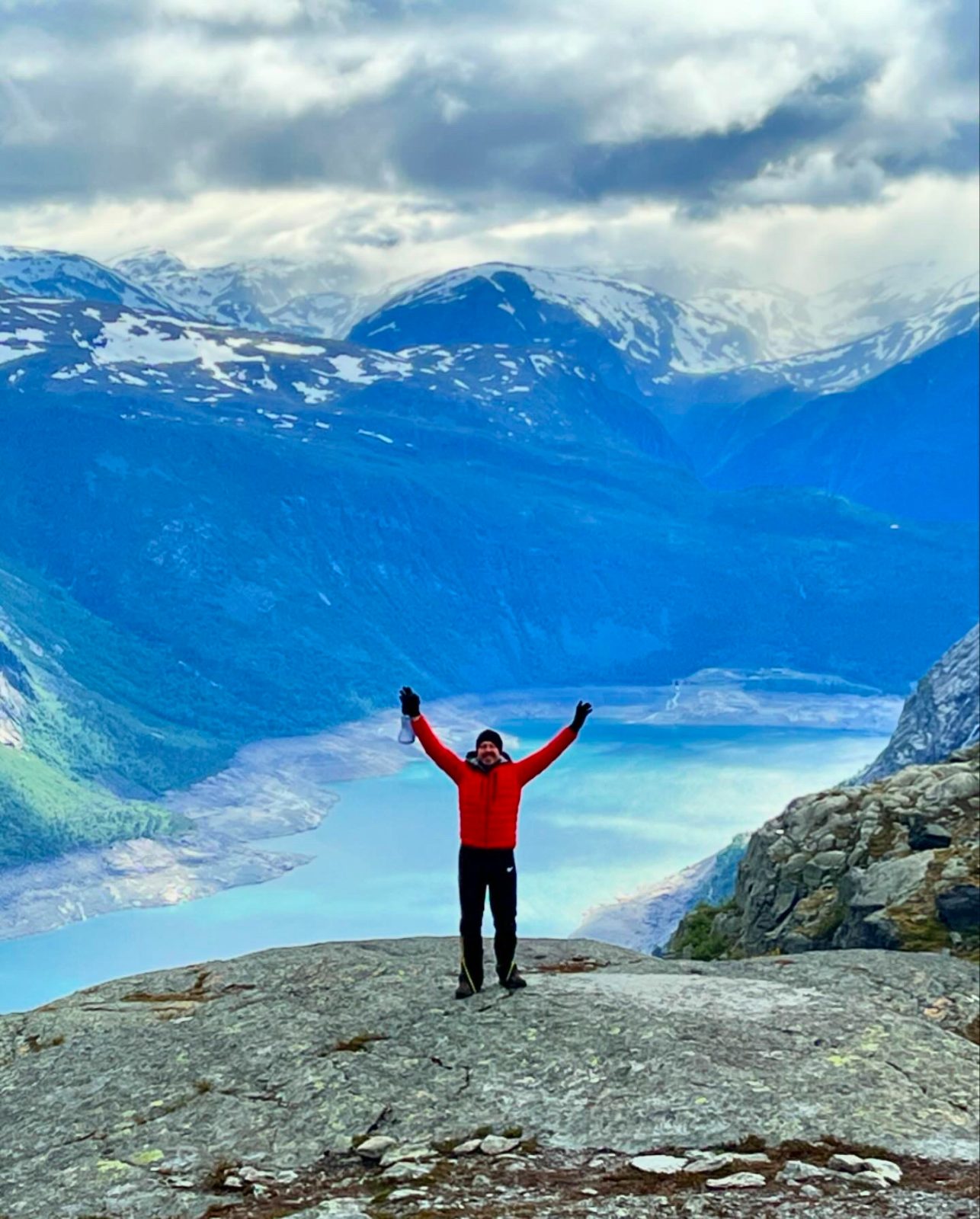 Made it, arms aloft above the fjord