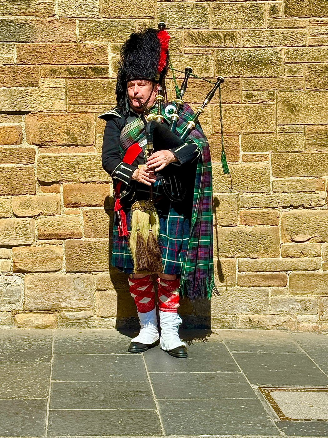 A piper outside the castle