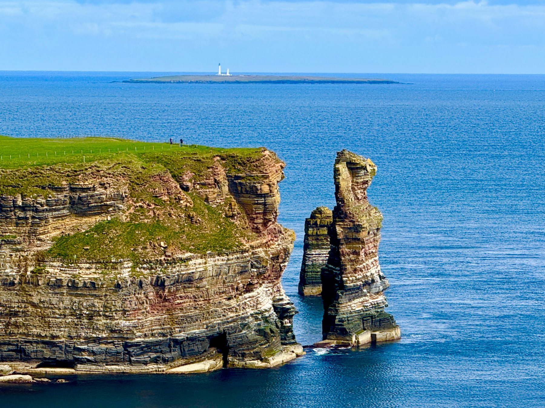 Sea stack and Stroma lighthouse beyond